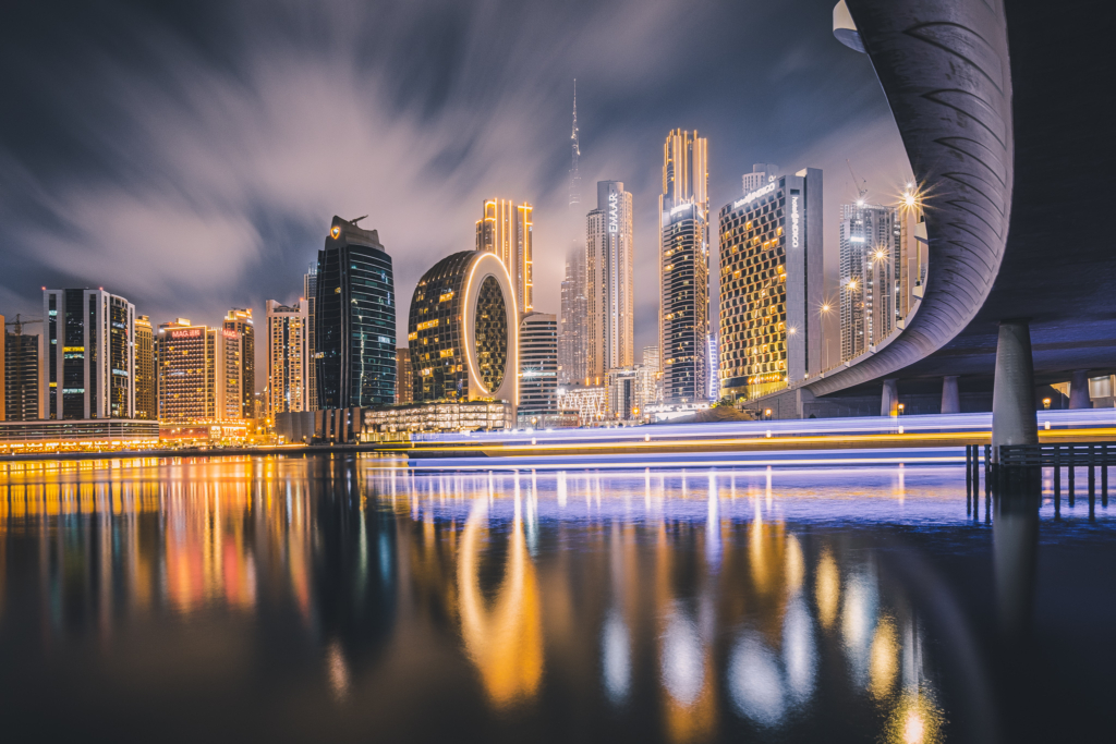 Panoramic view of Business Bay, Dubai, during sunset, with the skyline lit up.