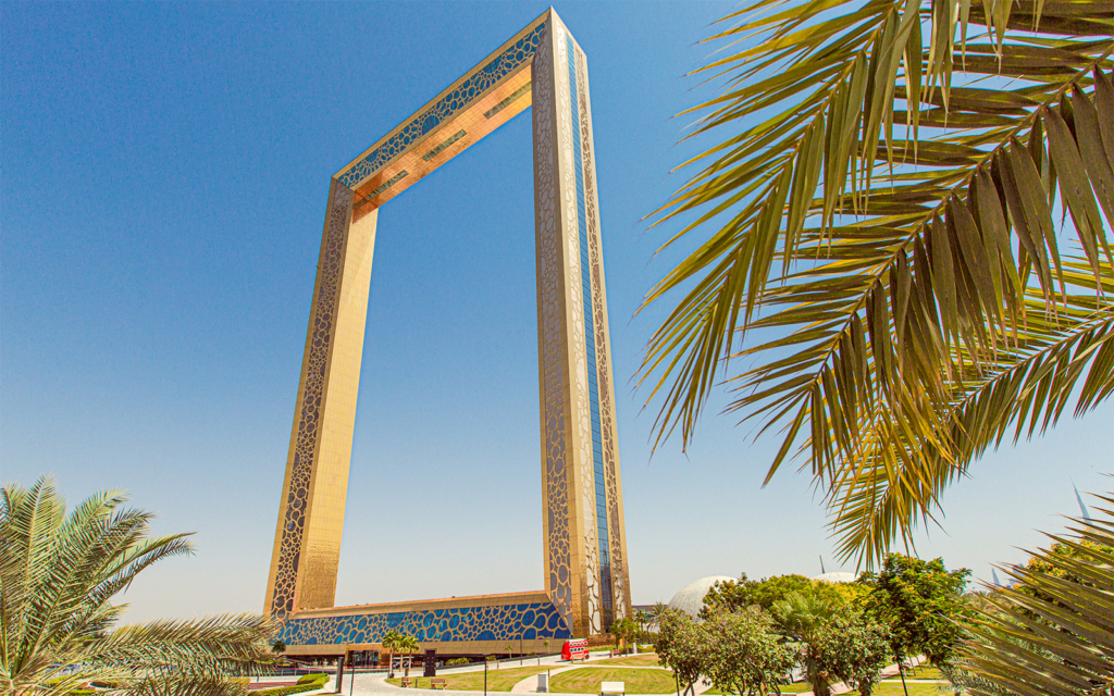 A stunning view of the Dubai Frame located in Zabeel Park, showcasing its massive structure and vibrant surroundings.