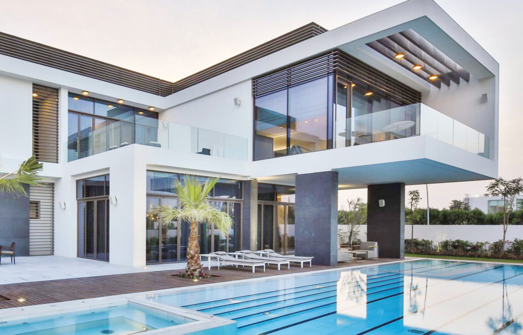 A luxurious villa in Dubai with a modern swimming pool and lush garden.