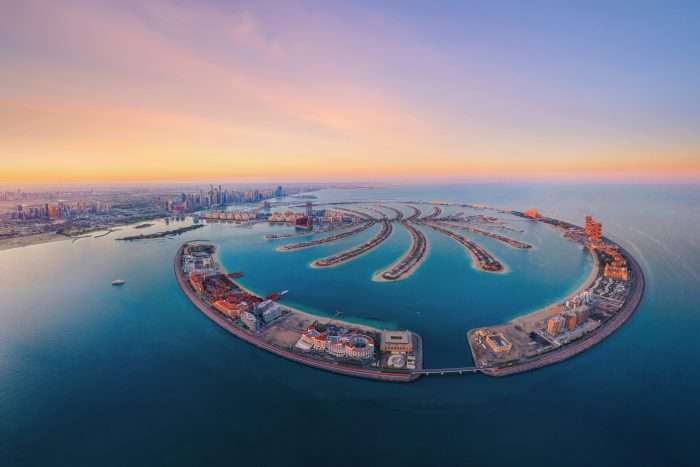 Panoramic view of Dubai's skyline showing luxury architecture with iconic area Palm Jumeirah.